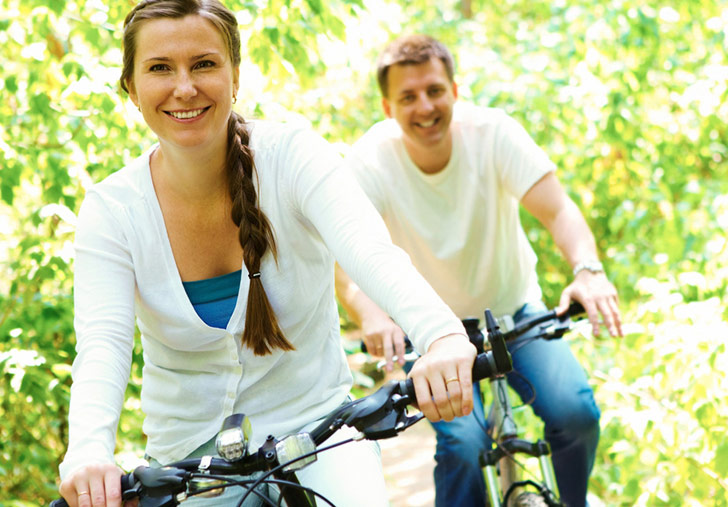 man and woman riding bicycles, wellness