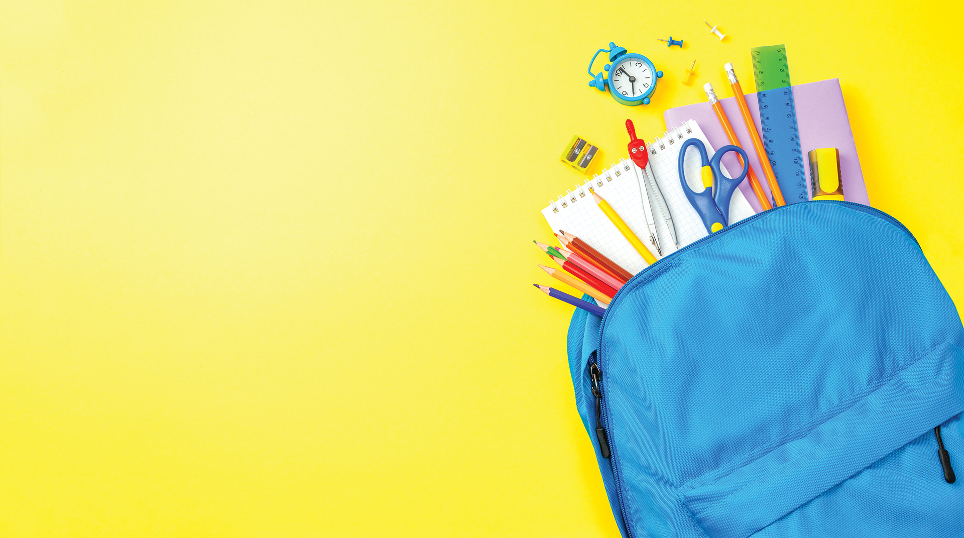 Photo with yellow background of back to school supplies