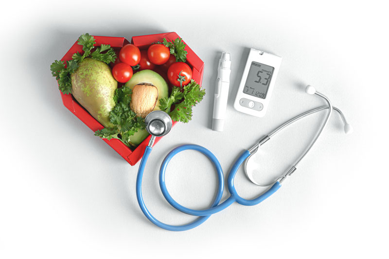 Photo of healthy food, stethoscope and blood sugar monitor