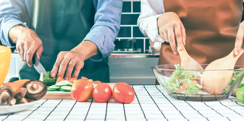 Two people preparing a healthy meal.