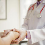 photo of healthcare provider holding patient's hands