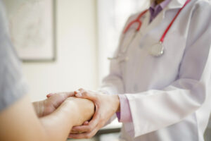 photo of healthcare provider holding patient's hands